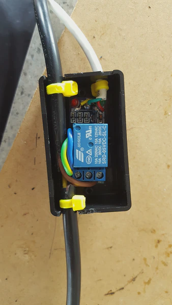 240V relay securely in a plastic case, inline with the light-hoods power cable. This part of the circuit is isolated from the Arduino board and only connects back to that via the white, low voltage cable.